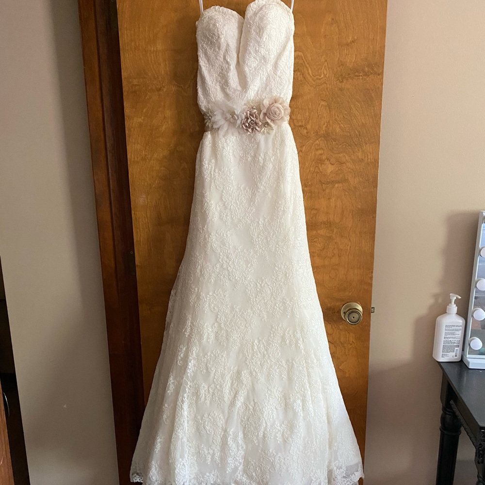 Used wedding dress only wore for a few hours. Only adjustments is a bra added.
